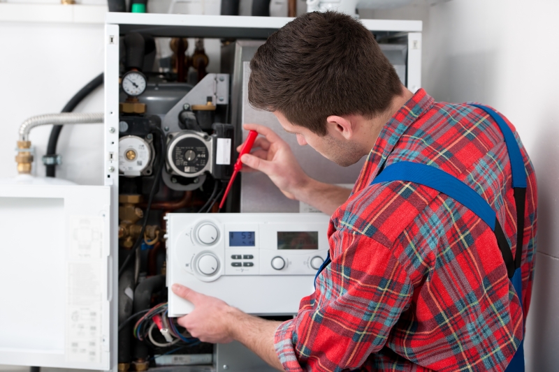 Gas Safe engineer working on a boiler in Brixton